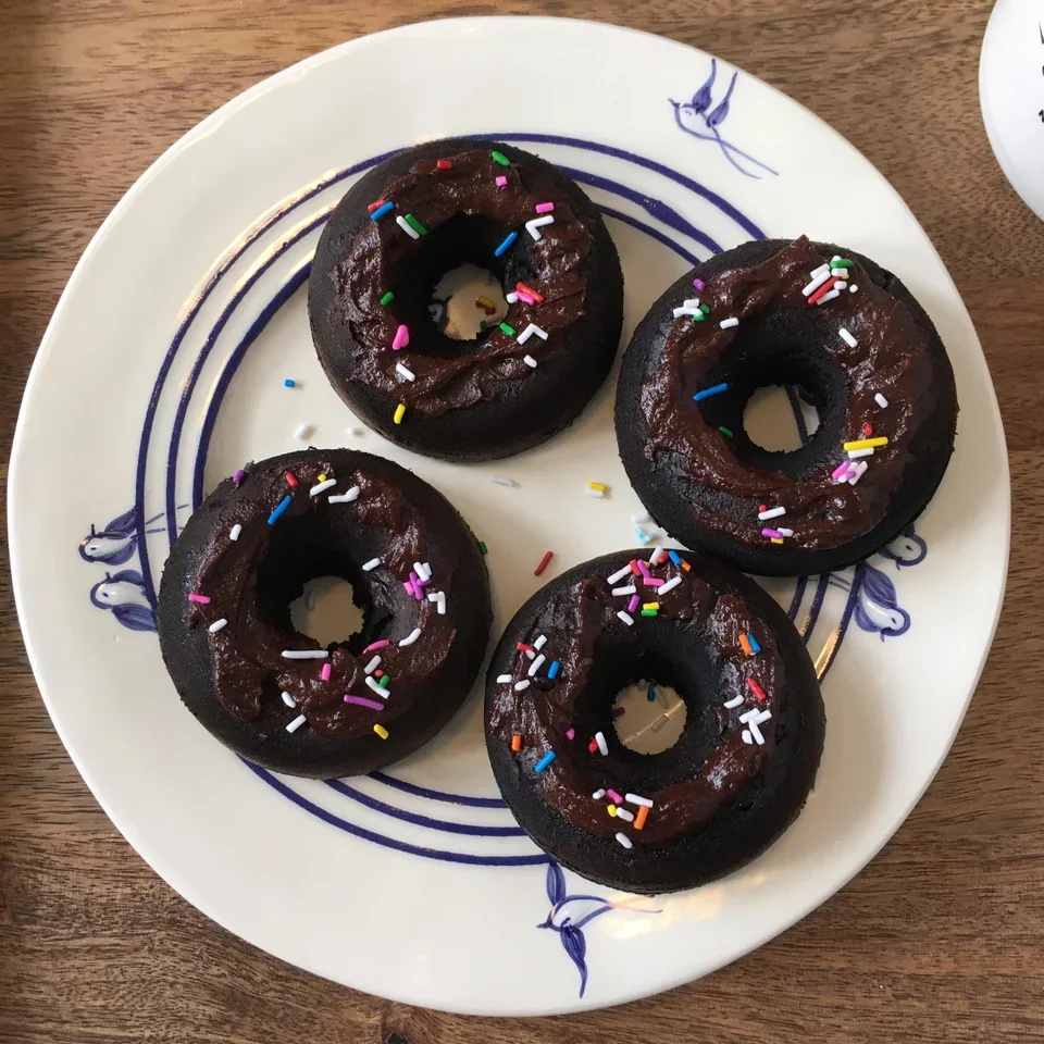 Boo's Ridiculous Brownies turned-donuts; frosted with chocolate spread and topped with multicolored sprinkles. Low calorie and high protein.