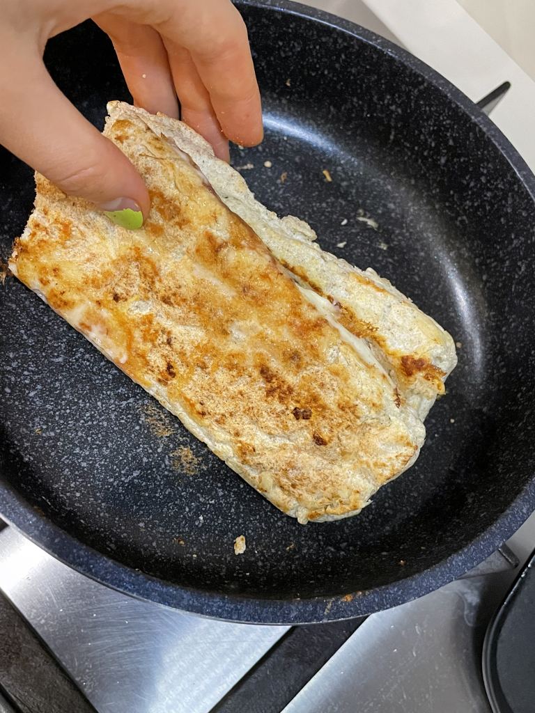 Close up of high protein, low calorie bread made with egg whites, psyllium husk, cream of tartar and protein powder. Grilled on the stove with cheese, lightly toasted.